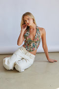 Style-image | Acacia Jacquard Halter Floral Corset | styled view of the floral corset top paired with white high-waisted pants.