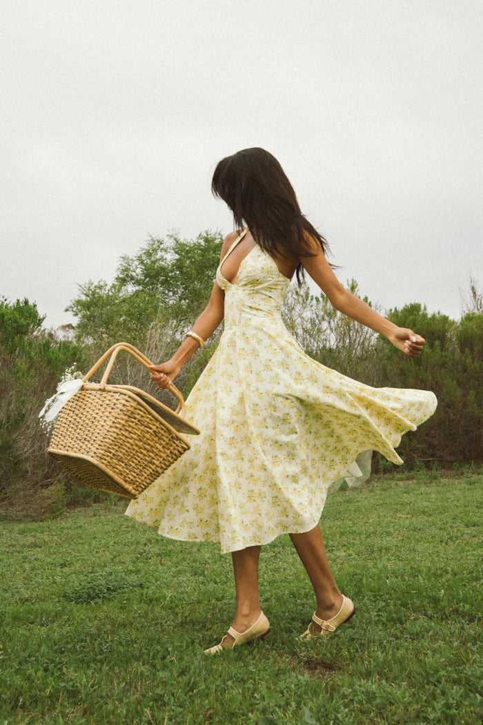 yellow-image | front-image | floral print dress | vibrant | the dress in a front view, featuring yellow floral patterns, a halter neck, and a flared skirt