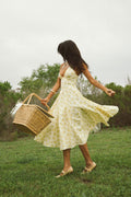 yellow-image | front-image | floral print dress | vibrant | the dress in a front view, featuring yellow floral patterns, a halter neck, and a flared skirt