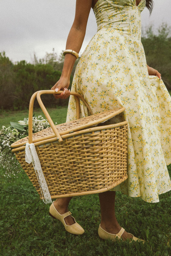 detail-image | floral print dress | soft and light | a close-up of the dress’s pleated skirt and the subtle pattern of yellow florals
