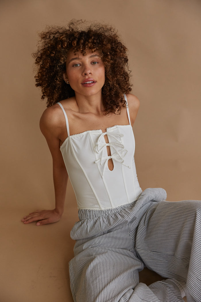 white bow front corset top with keyhole cutout
