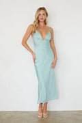 Woman wearing a light blue dress against a white background