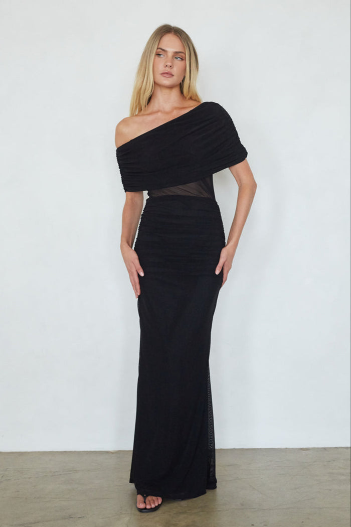 Woman wearing a black off-shoulder gown against a white background