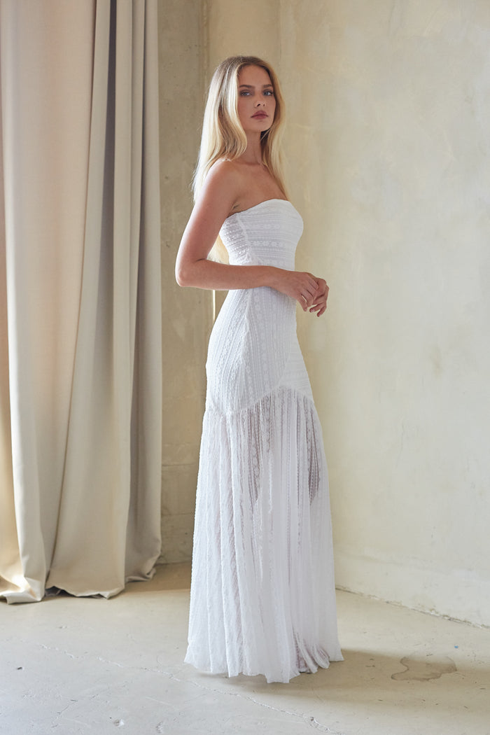 Side-image | White Strapless Dress | side view displaying the elegant drape of the skirt with a side slit for added movement.
