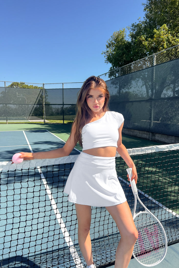 White high-waisted flare tennis skort with built in pockets and shorts - trendy activewear