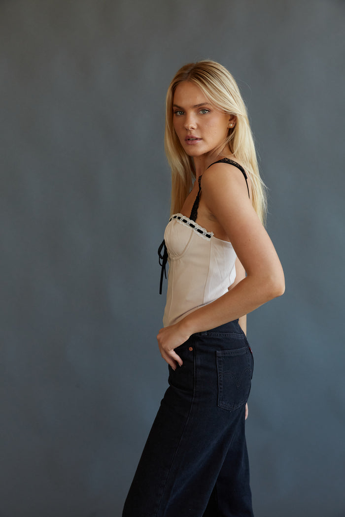 cream lace trim corset top with black ribbon detail