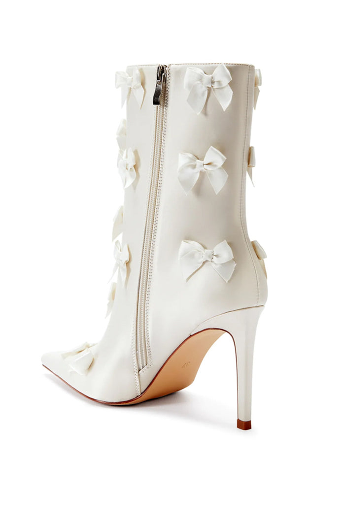 inner side view with zipper of a pointed toe satin bootie with stiletto heels and decorative bots all over - white shoes for brides - what to wear for a bridal shower