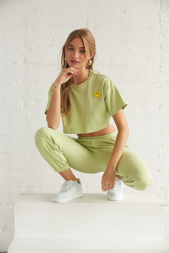 Model posing in green crop top