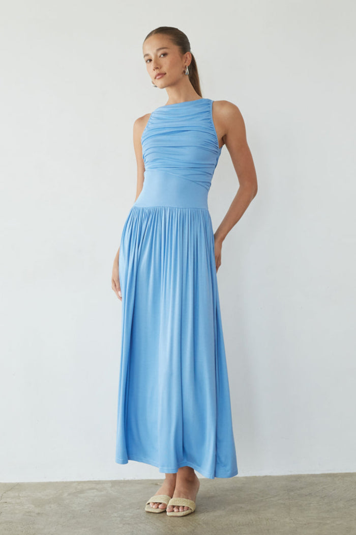 Woman wearing a light blue dress against a plain background