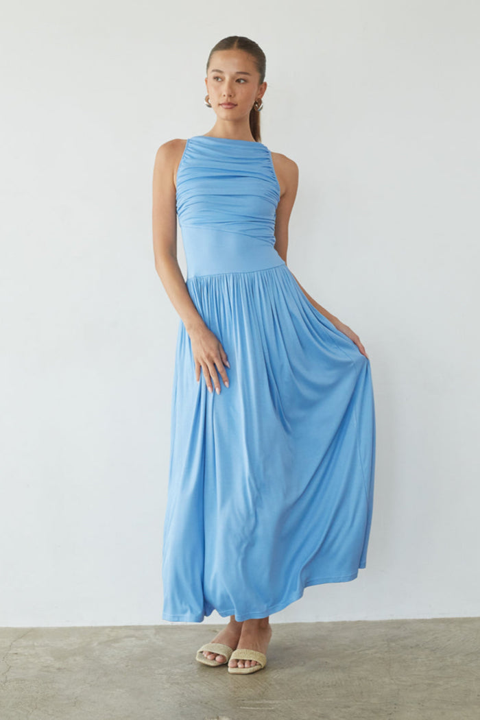 blue-image | Woman wearing a blue dress against a white background