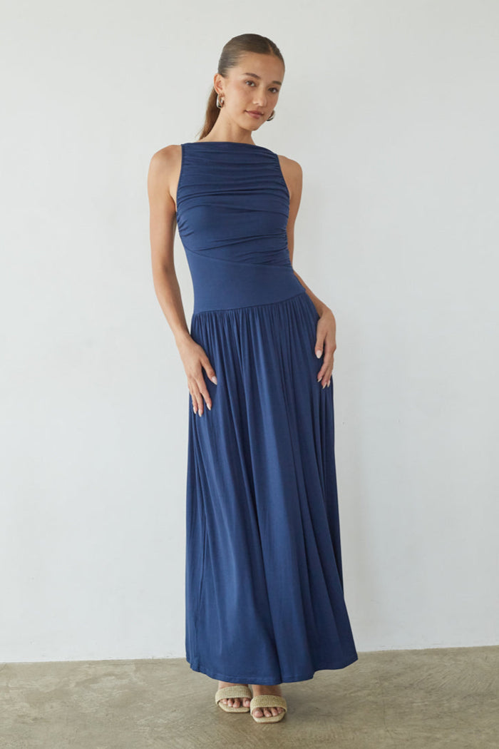 Woman wearing a blue dress against a plain background