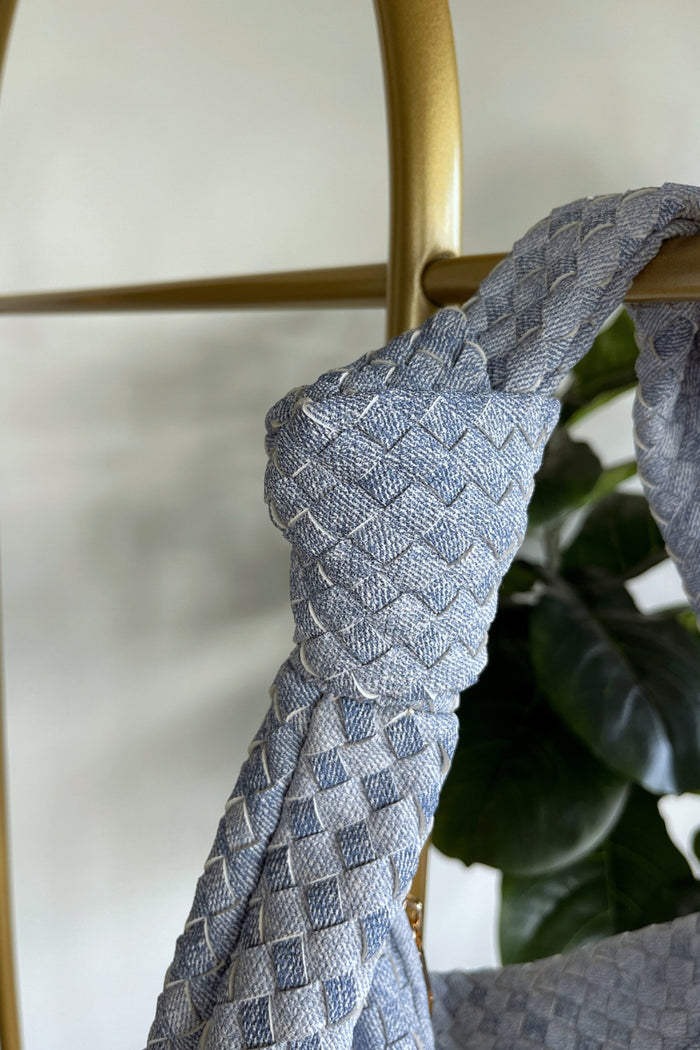 light blue knotted detail on purse