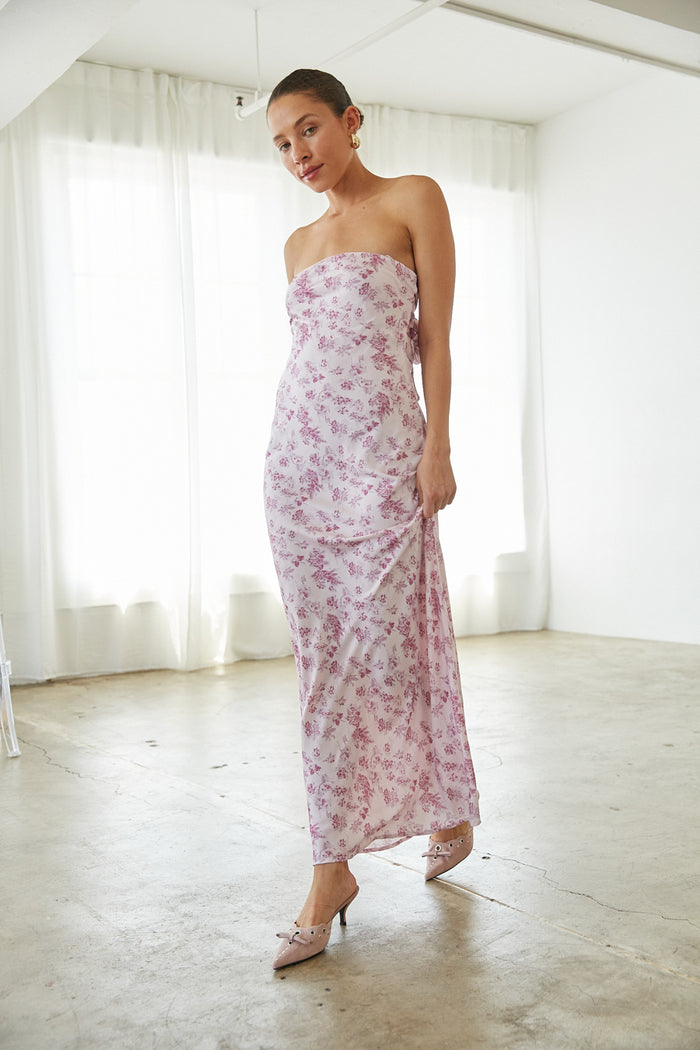 pink-image | Woman in a strapless floral maxi dress from American Threads, ideal for graduation dresses.