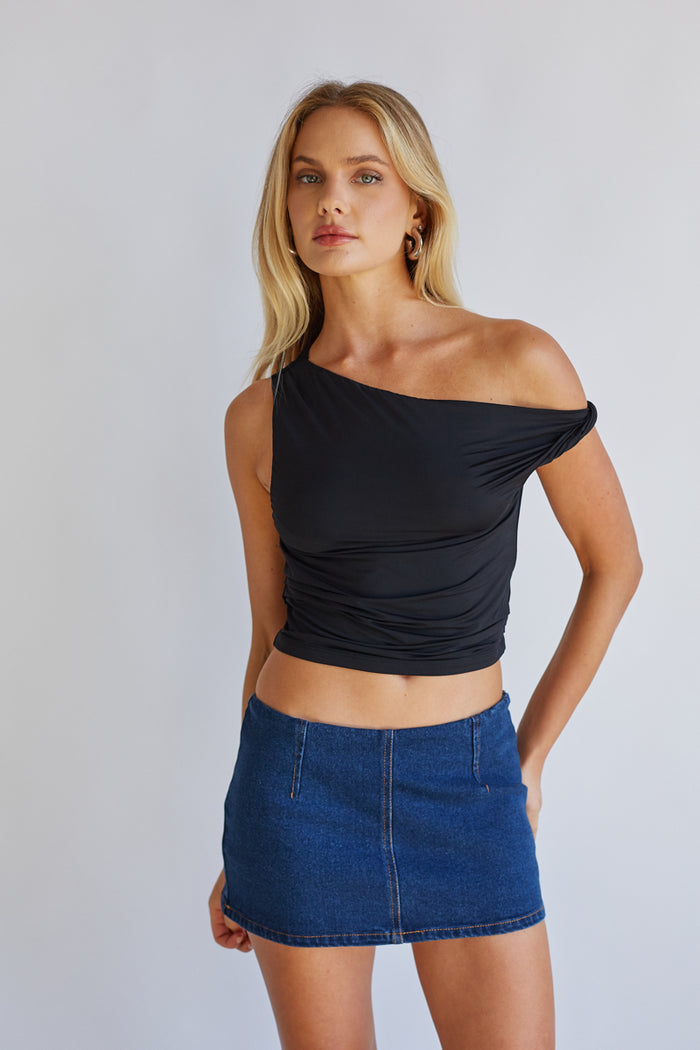 black-image | Detail-image | Off the Shoulder Twist Top | close-up showing the twist detail of the top and the smooth fabric texture.
