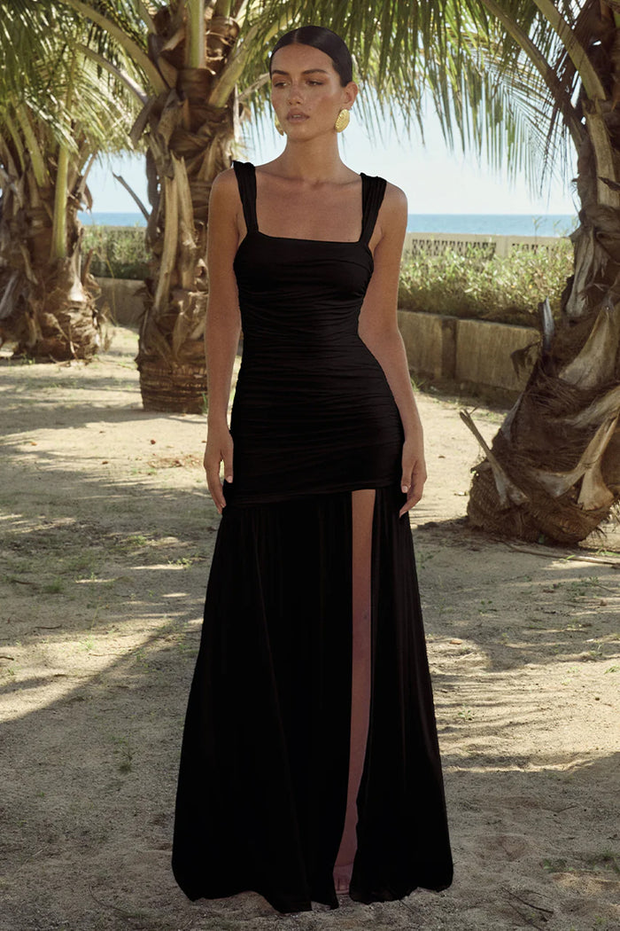 black-image | front image | Carly Maxi Dress | front view showcasing a fitted bodice with pleating and a thigh-high slit, emphasizing the elegant look.