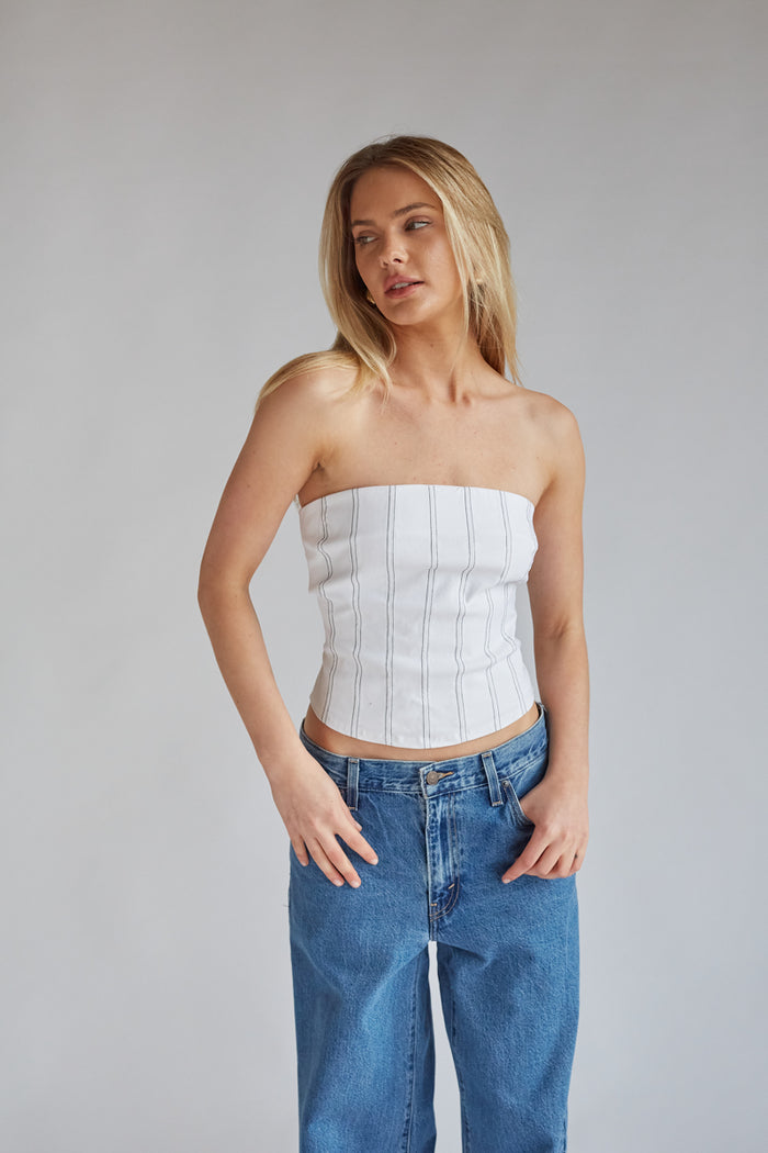 white strapless corset top with black vertical stitch stripes | game day outfit inspo