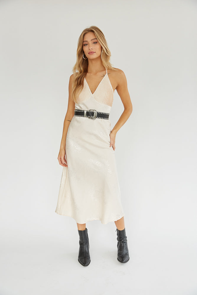 Nude floral midi dress paired with a studded black belt