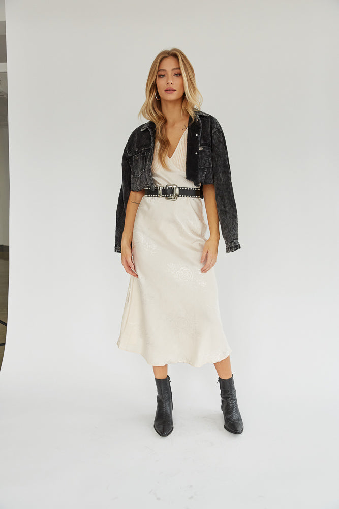 Cream floral midi dress paired with black belt, black jacket, black boots