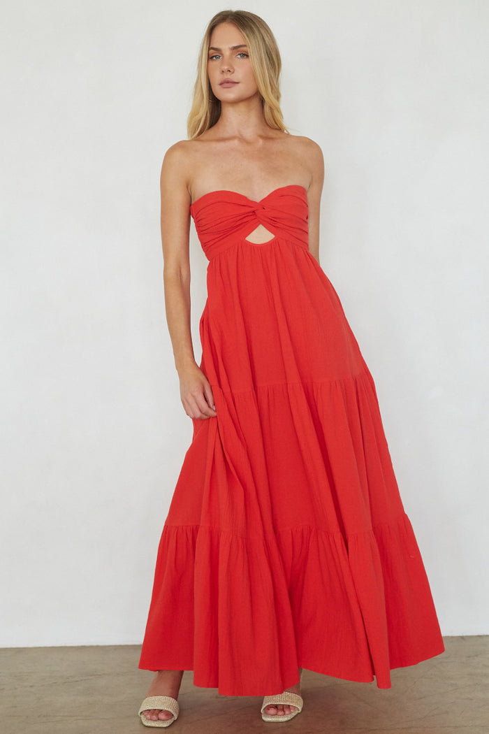 red-image | Woman wearing a red strapless dress against a white background