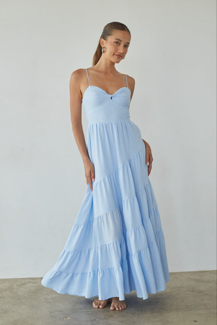 blue-image | Woman wearing a light blue dress against a plain background