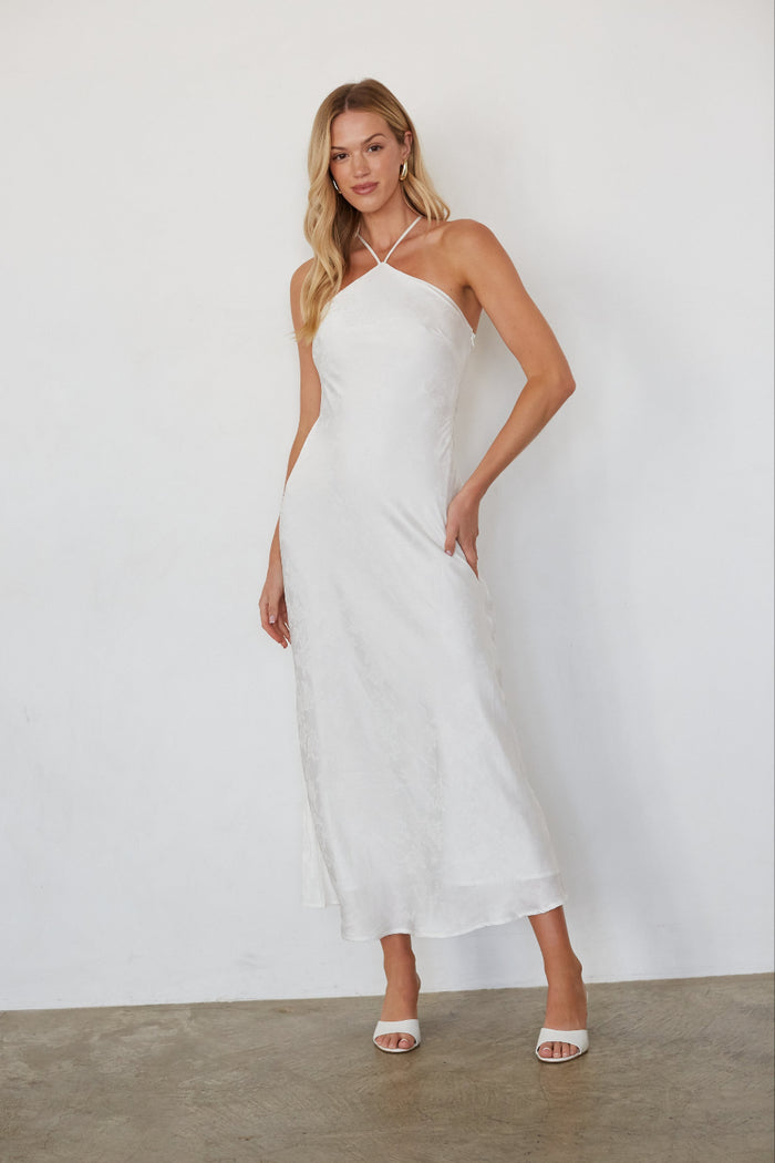 white-image | Woman wearing a white dress against a plain background