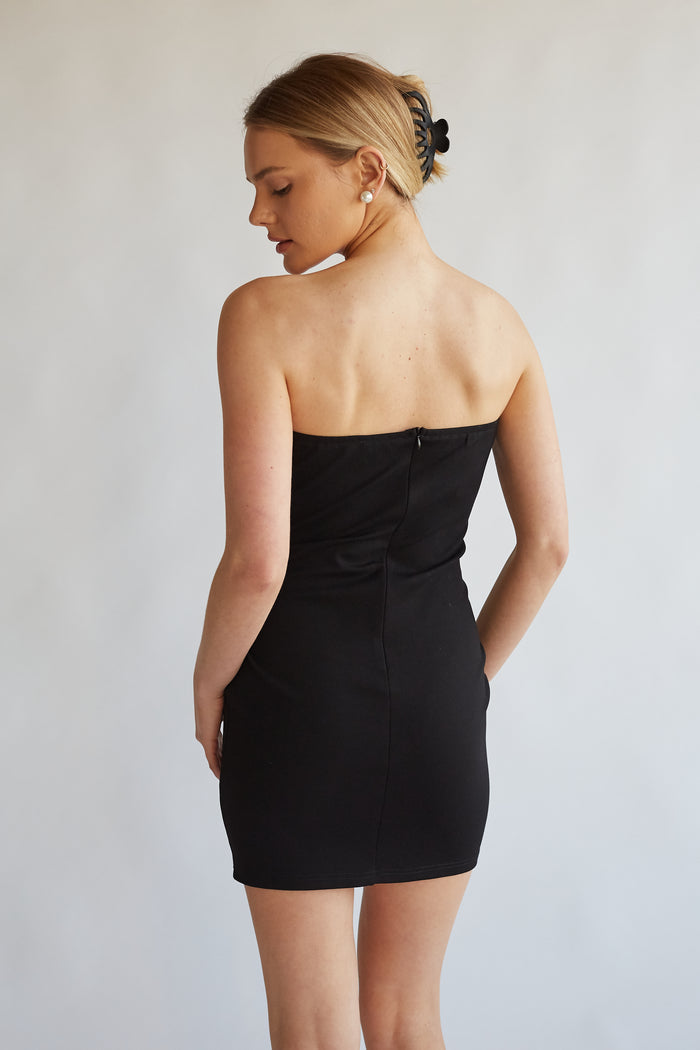 back view of black strapless contrast mini dress with back zip enclosure