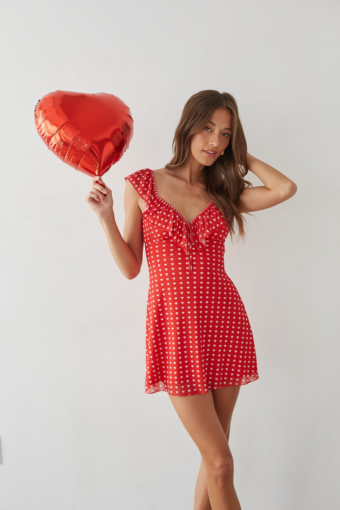 front-image | Valentine's Day dress | sweetheart neckline mini dress | cute and flirty outfit | red ruffled mini dress with a heart pattern, perfect for date nights