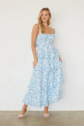 blue-image | Woman wearing a blue floral dress against a white background