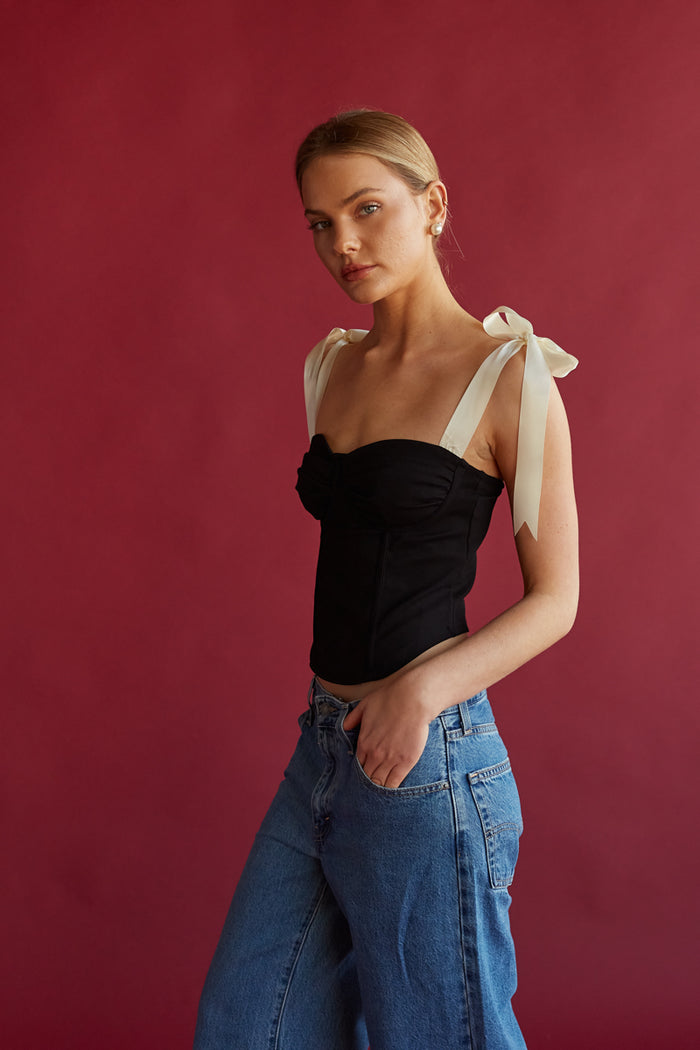 black bustier corset top with white ribbon bow straps | trendy unique date night outfit