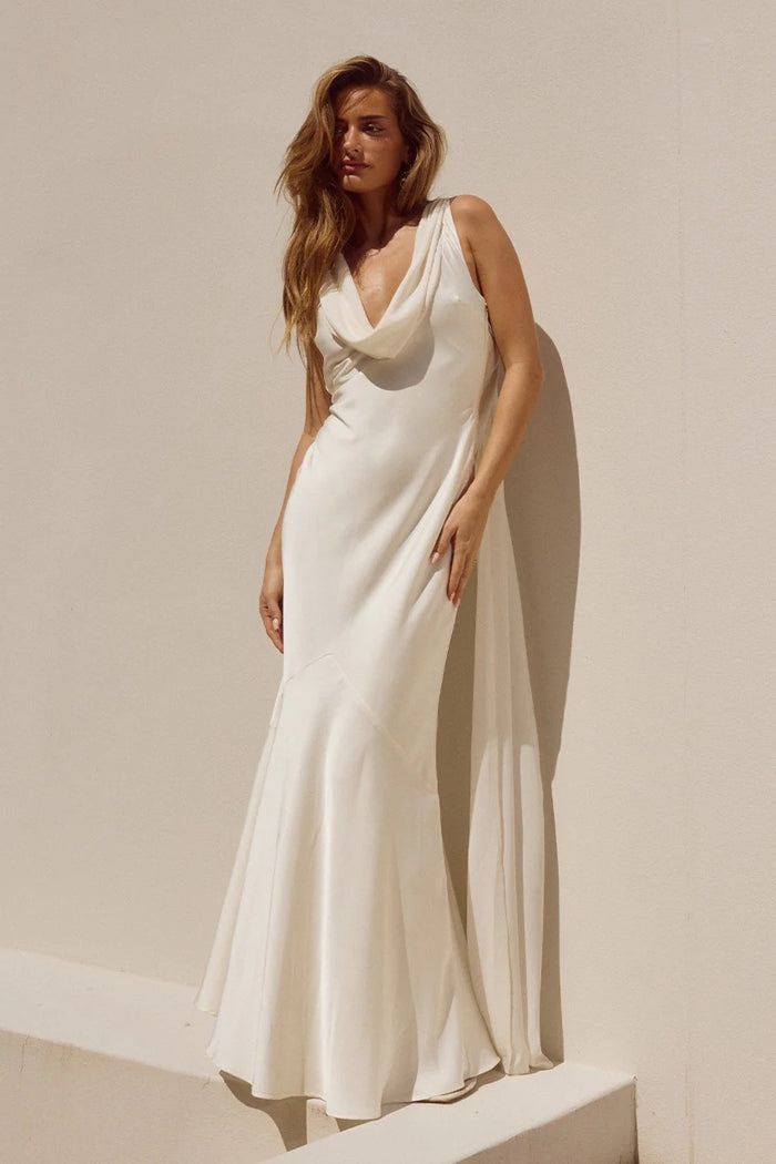 white-image | Woman wearing a white sleeveless dress against a plain background