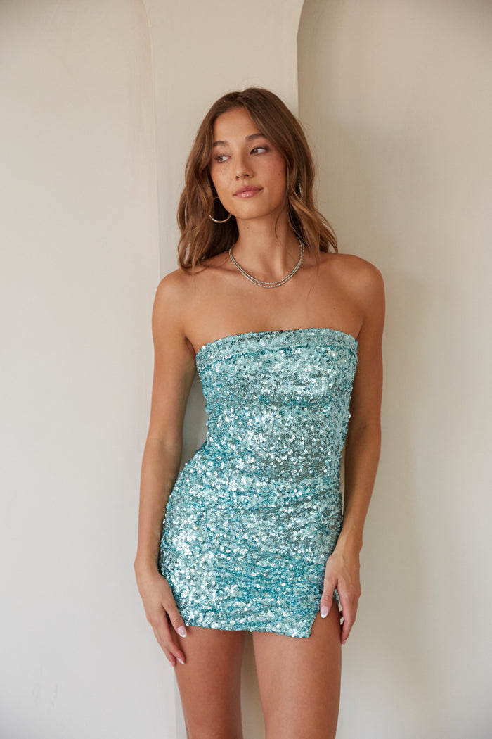 blue-image | A lady in a strapless turquoise sequin mini dress, ideal for hoco dresses or unique homecoming dresses.