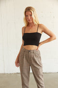 Cropped black ribbed tank top with spaghetti straps.