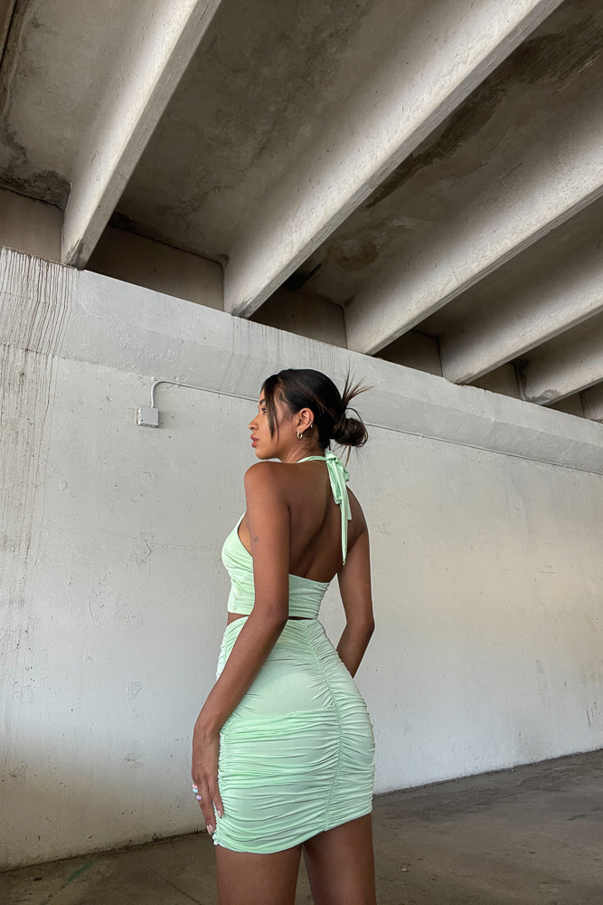 Back view of cinched green skirt set