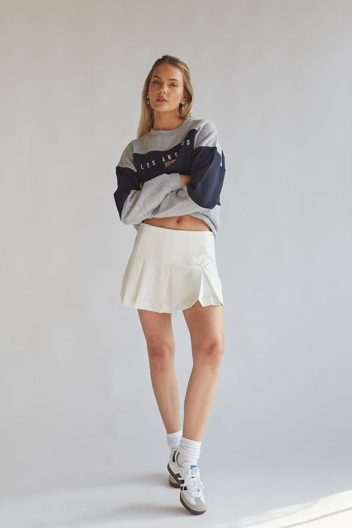 drop waist white pleated mini skirt