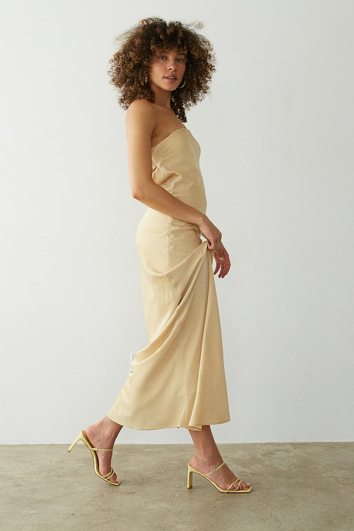 walking view | mustard yellow open back cowl back satin maxi dress