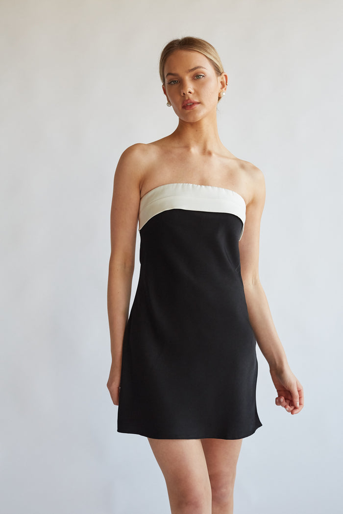 A girl in a strapless black and white mini dress from American Threads, perfect for unique homecoming dresses.