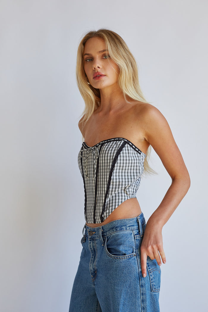 black-image | Side-image | Black Gingham Front Tie Corset | side view highlighting the fitted design and side seam of the gingham corset top.