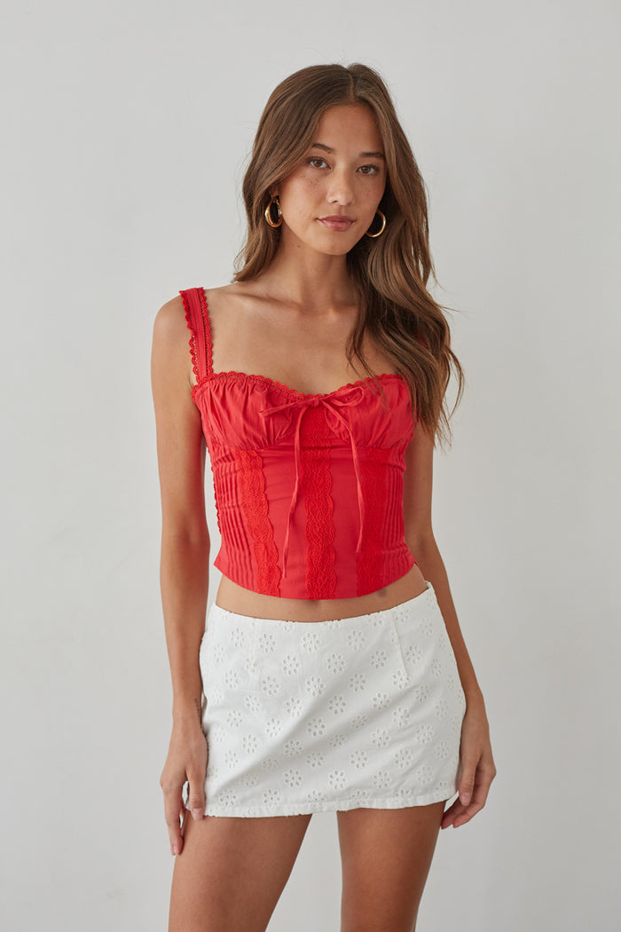 white-image | Front-image | Eyelet Lace Mini Skort | front view showcasing the red lace tie-top and white eyelet lace mini skort with floral detailing.