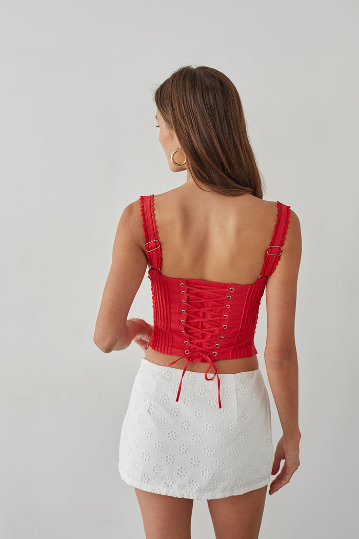 Back-image | Eyelet Lace Mini Skort | back view of the red lace tie-top and white skort with a clean finish and visible lace trim.