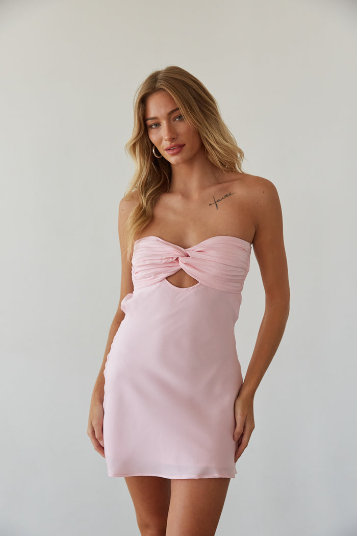 Woman in a pink babydoll dress by American Threads, perfect for unique hoco dresses or formal mini dresses.