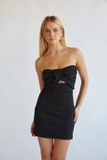 black-image | Woman in a strapless black bodycon mini dress from American Threads, ideal for homecoming or formal events.