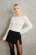 white ivory lightweight bell sleeve loose knit sweater - black high rise mini skort