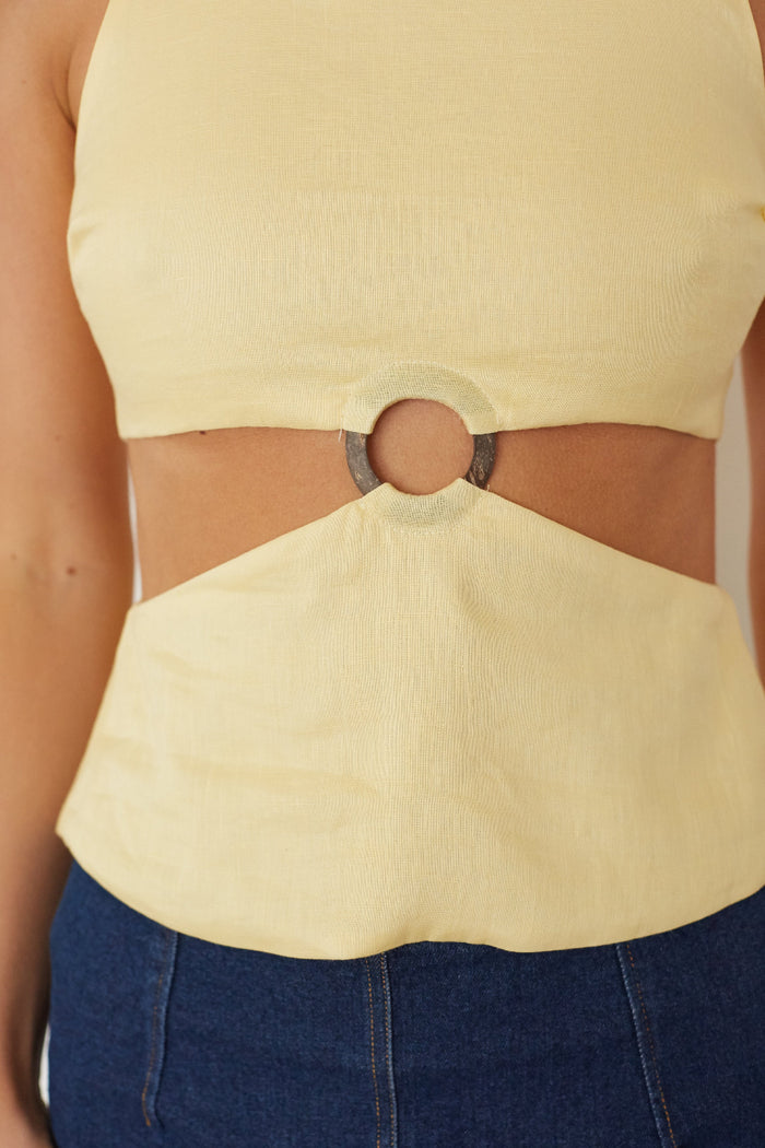 Yellow top with cut-out design and blue pants