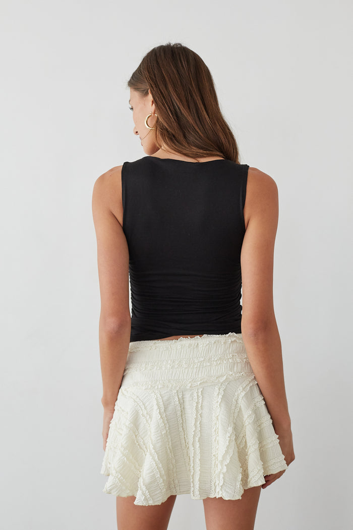 Back-image | Lace Skater Skirt | back view emphasizing the skirt’s layered design and the simple yet stylish black top.