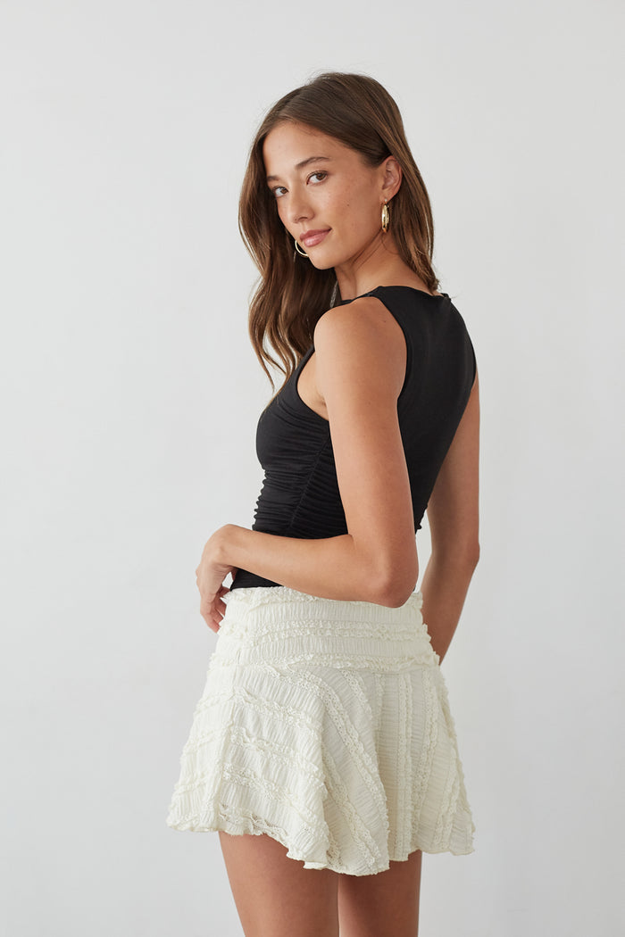Side-image | Lace Skater Skirt | side view emphasizing the tiered ruffled design of the skirt and the fitted top.