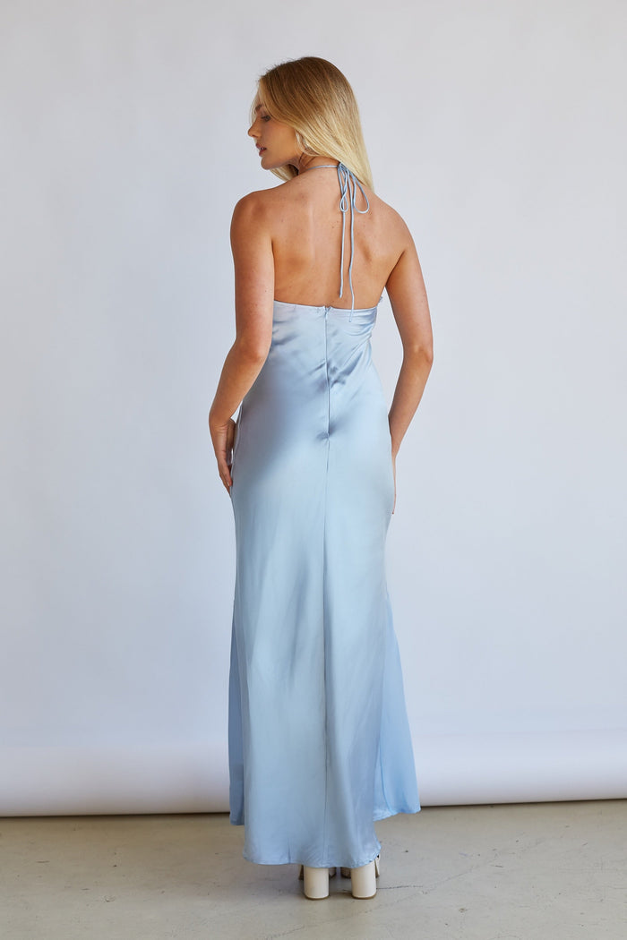 Back-image | Satin Midi Dress | back view highlighting the halter straps and the elegant flow of the light blue satin fabric at the skirt.