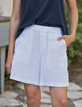 Person wearing white shorts and navy top outdoors