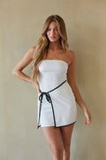 white-image | front image | Maisie Contrast Mini Dress | front view featuring a strapless design with a black contrast tie around the waist, showcasing a clean, minimalist look.