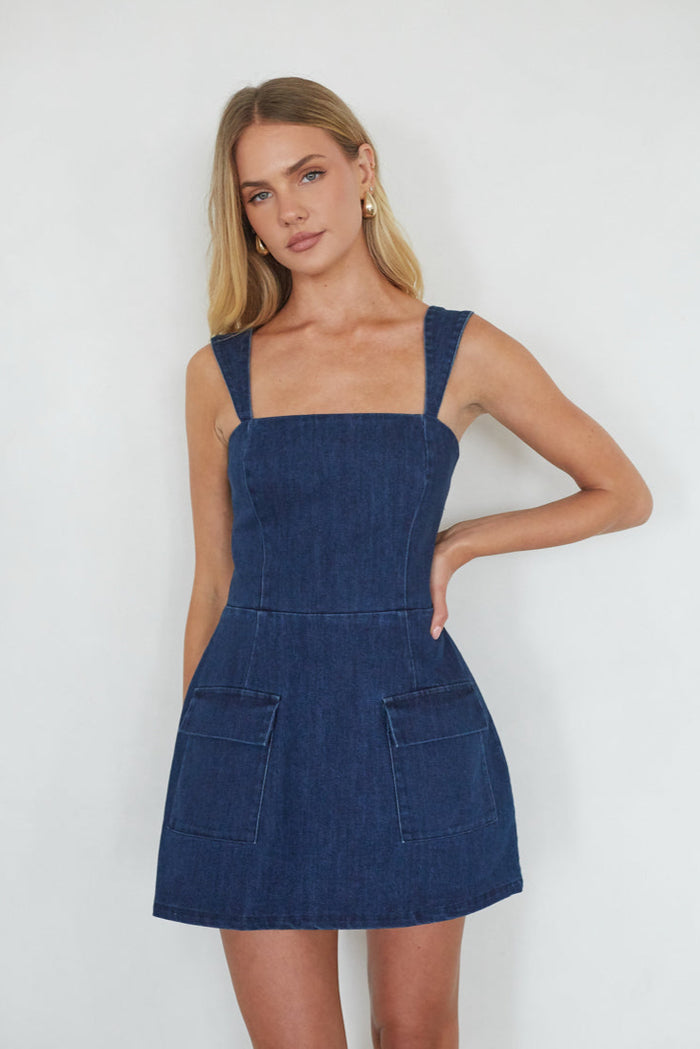 blue-dress | Woman wearing a blue denim dress against a white background