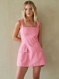 pink-image | Woman wearing a pink dress against a beige background